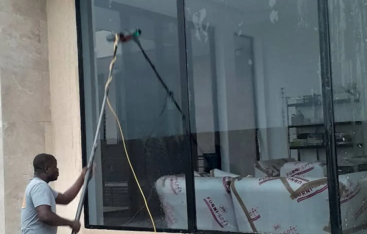 JuKaro worker cleaning glass windows to a spotless finish